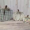 Three Wooden Pumpkins painted in plaid, white and blessed.